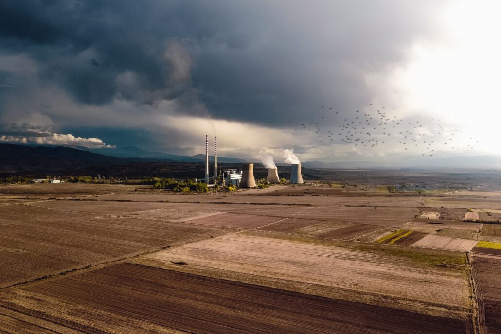 pexels-photo-6081370-6081370 Aerial view of empty fields near atomic power station generating energy and polluting atmosphere